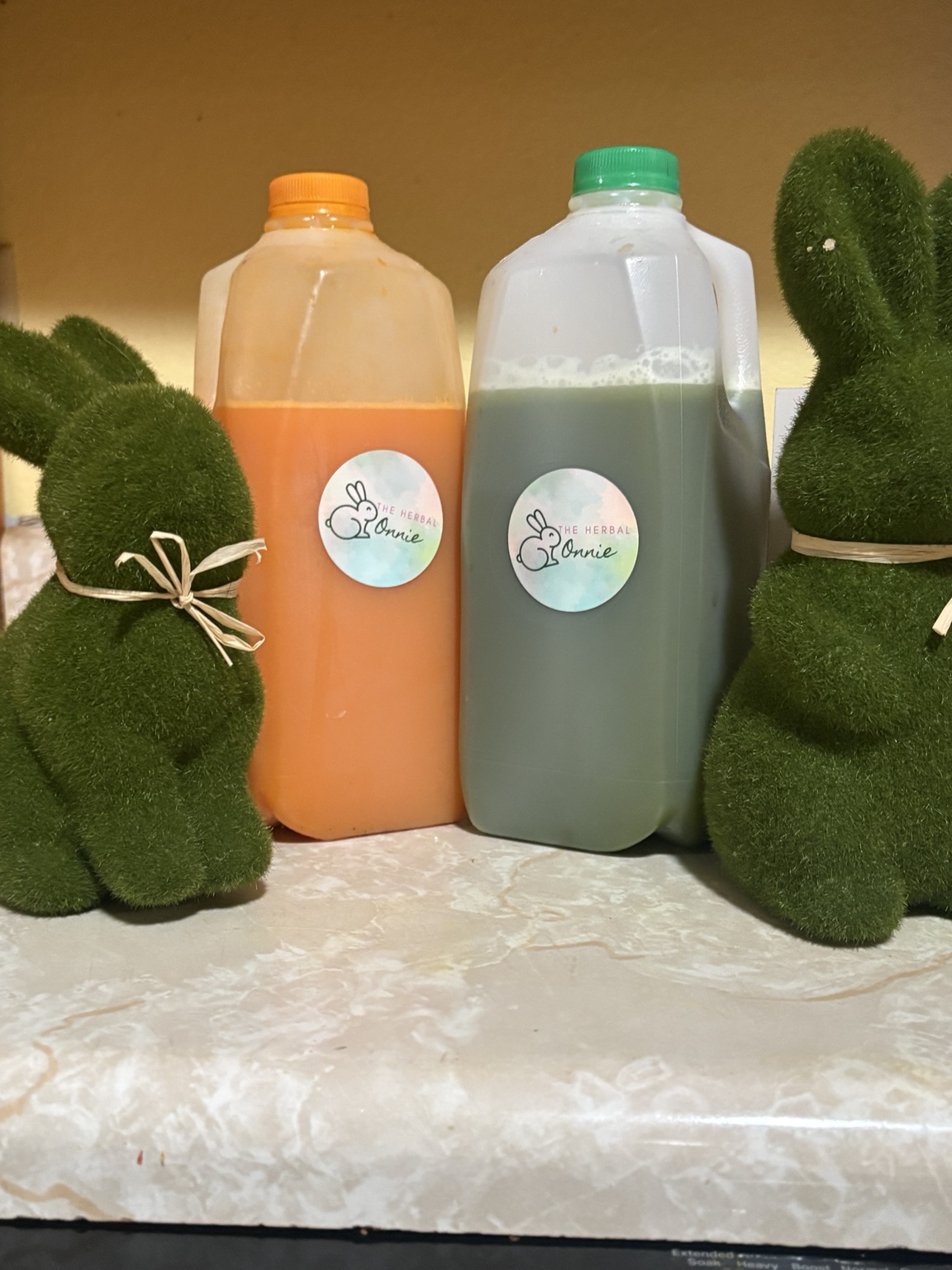 The Herbal Bonnie tea jugs displayed with green rabbit decorations